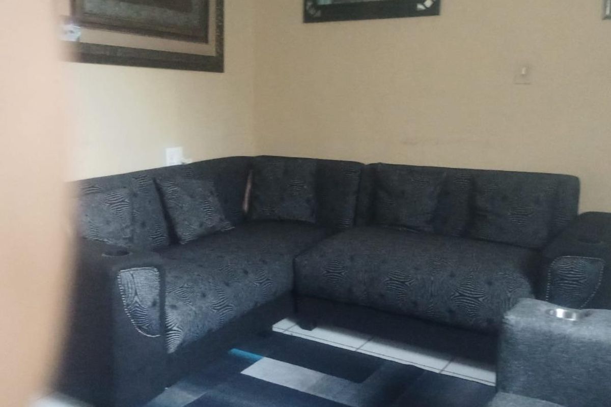 A living room area featuring tiled flooring and neutral wall finishes.