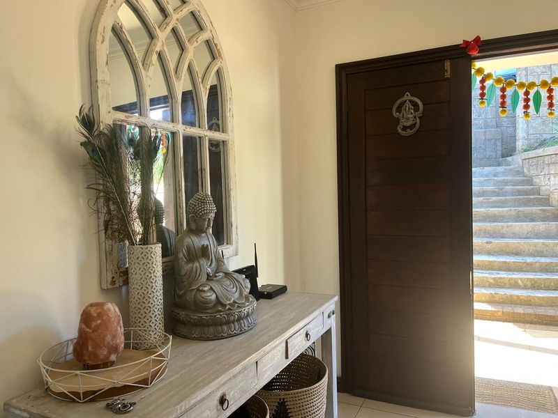Welcoming entrance area featuring a solid timber door opening to an exterior staircase, complemented by neutral tiled flooring.