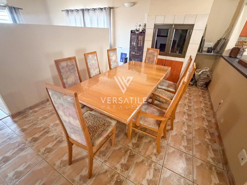 Dining area featuring tiled flooring and built-in cabinetry, adjacent to the kitchen space.