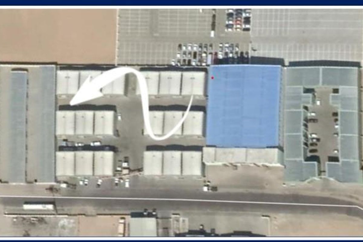 Aerial view of an industrial warehouse complex featuring multiple storage units, metal roofing, and paved parking areas.