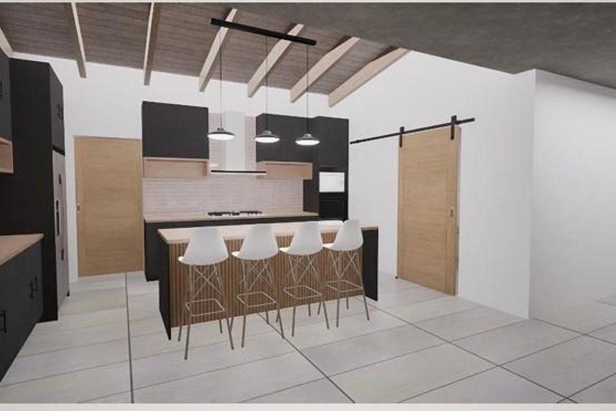 Modern open-plan kitchen featuring dark cabinetry, a central island with breakfast bar seating, exposed timber ceiling beams, and a sliding barn-style door.