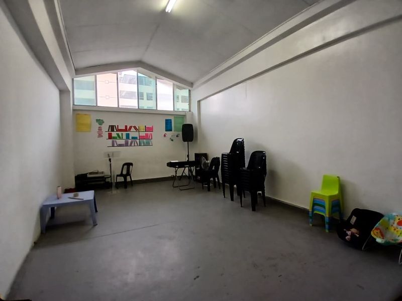 A spacious, open-plan office or multi-purpose room featuring a high vaulted ceiling and large clerestory windows providing ample natural light.