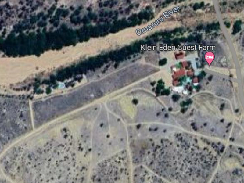 Aerial view of the small holding property situated along the Omaruru River, showing the main guest farm buildings and surrounding landscape.