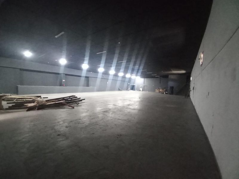 Large, open-plan industrial utility space featuring concrete flooring, recessed lighting, and an expansive, unobstructed layout suitable for various commercial or storage applications.