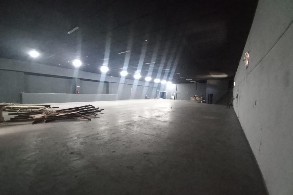 Large, open-plan industrial utility space featuring concrete flooring, recessed lighting, and an expansive, unobstructed layout suitable for various commercial or storage applications.