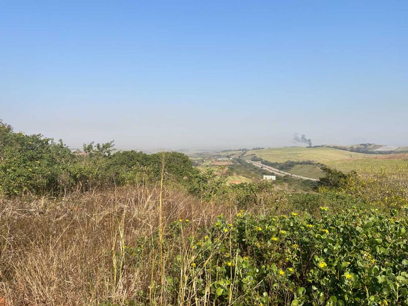 A wide-angle view of the surrounding landscape and natural terrain, showcasing the open space and distant horizon.