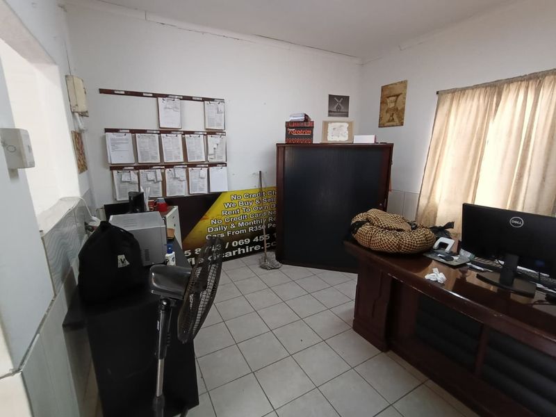 A functional office space featuring tiled flooring and neutral wall finishes, suitable for a professional work environment.