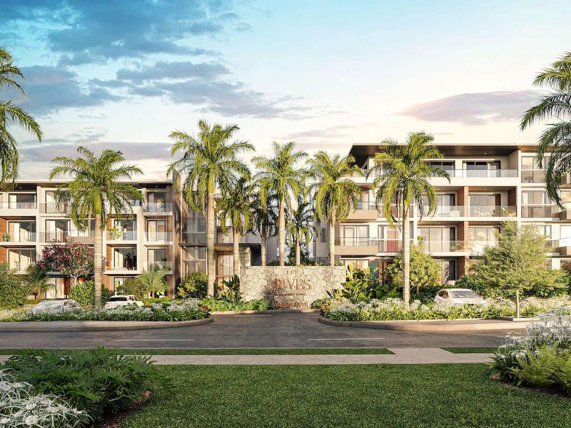 A high-quality architectural rendering of a modern residential apartment complex featuring landscaped gardens, palm trees, and a prominent stone entrance sign.
