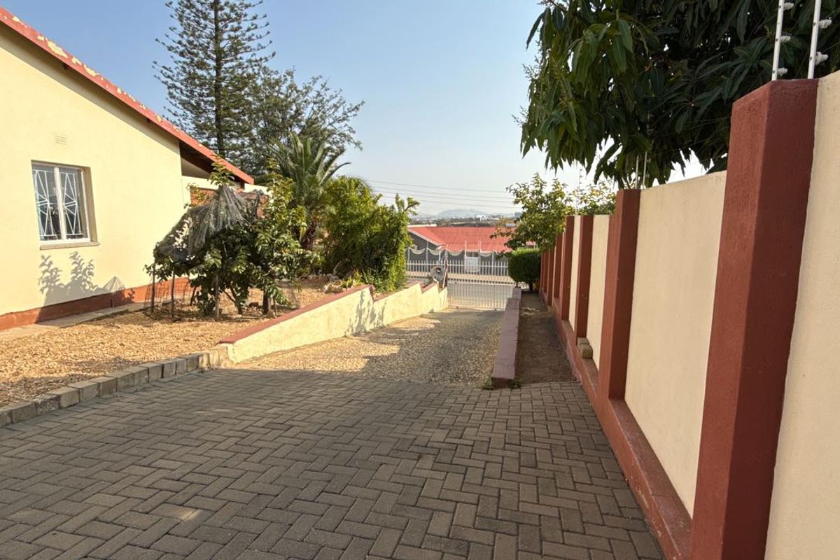 Set high above street level on a massive erf with a large front garden and elevated views - Photo 3