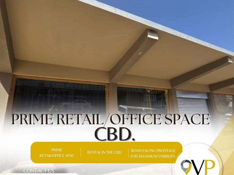 Commercial retail or office frontage located in the CBD, featuring large display windows, a covered walkway, and a secure roller shutter door.