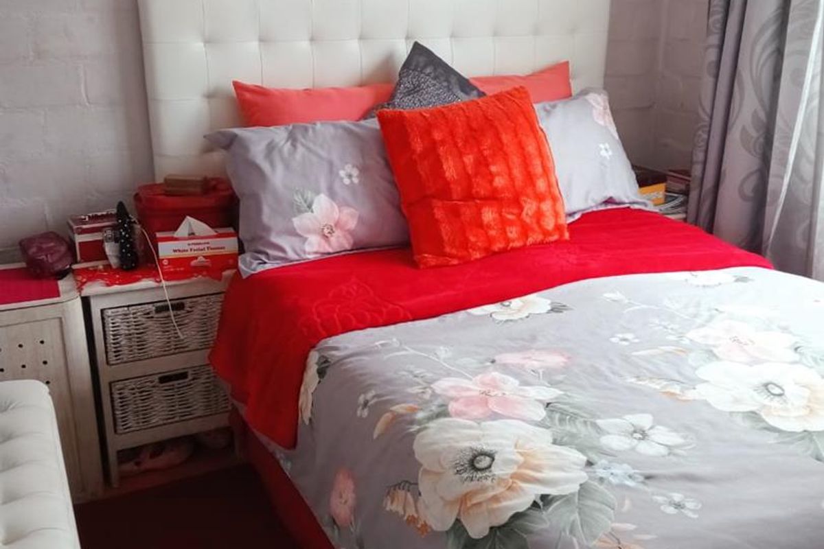 A bedroom featuring a painted brick wall finish, providing a neutral backdrop for the sleeping area.