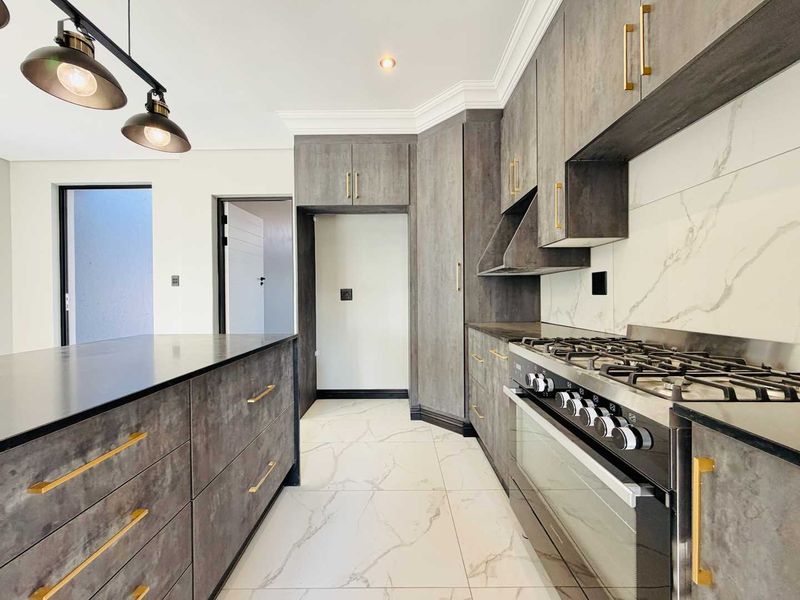 Modern kitchen featuring dark textured cabinetry, marble-look splashback, gas cooktop, built-in oven, and high-quality porcelain floor tiles.