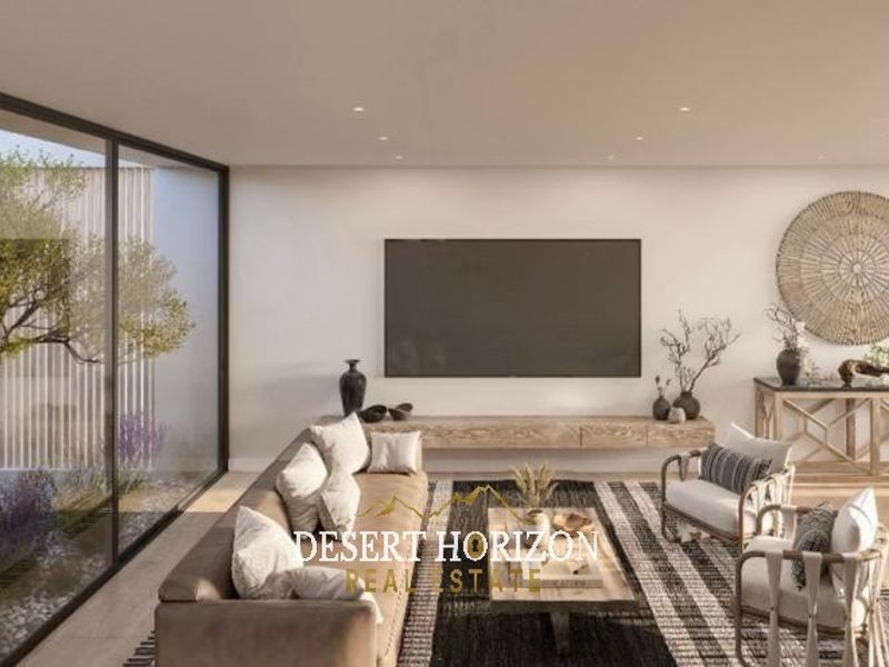 Modern open-plan living area featuring floor-to-ceiling windows, recessed lighting, and a sleek floating media console, seamlessly connecting to the dining space.