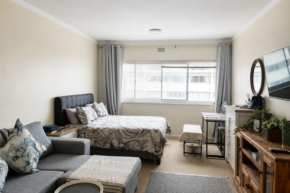 A well-maintained bedroom featuring neutral walls, carpeted flooring, and a large sliding window that allows for natural light.