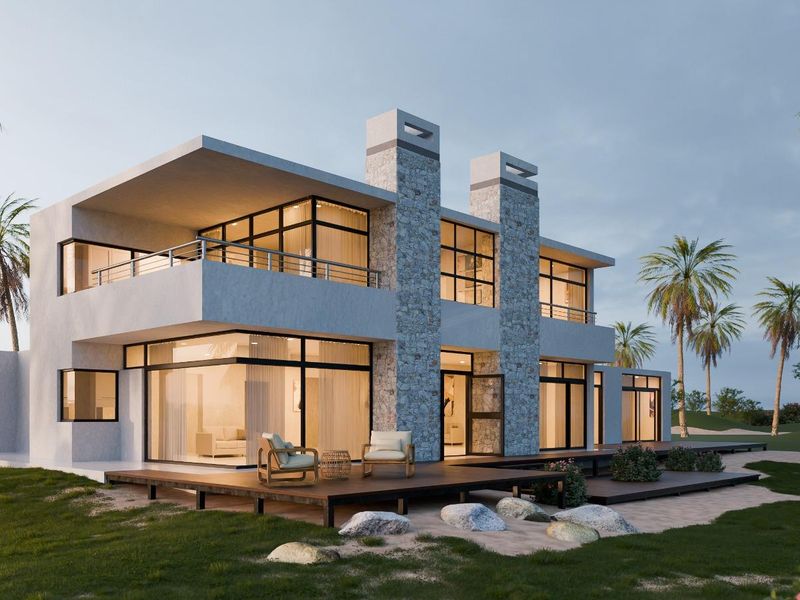A modern two-story residential property featuring stone chimneys, expansive glass sliding doors, and a spacious timber deck overlooking a landscaped garden.