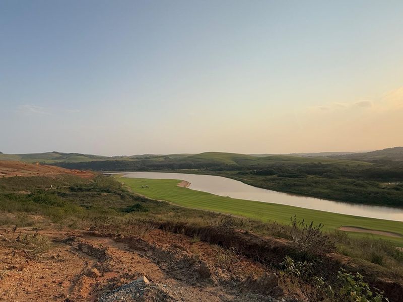 A scenic view overlooking a lake and golf course landscape from an elevated position on the vacant residential land.