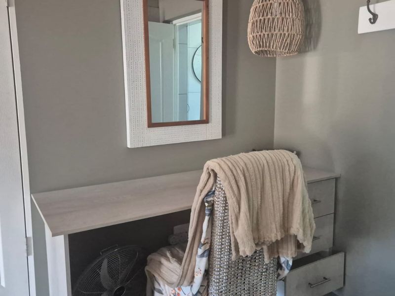 A bedroom corner featuring a built-in desk area with neutral wall tones and a functional layout.