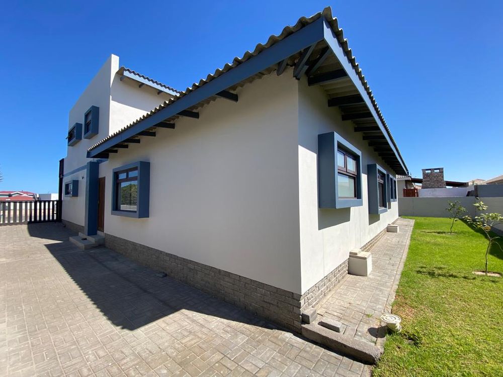 Side of the house and the caport parking area