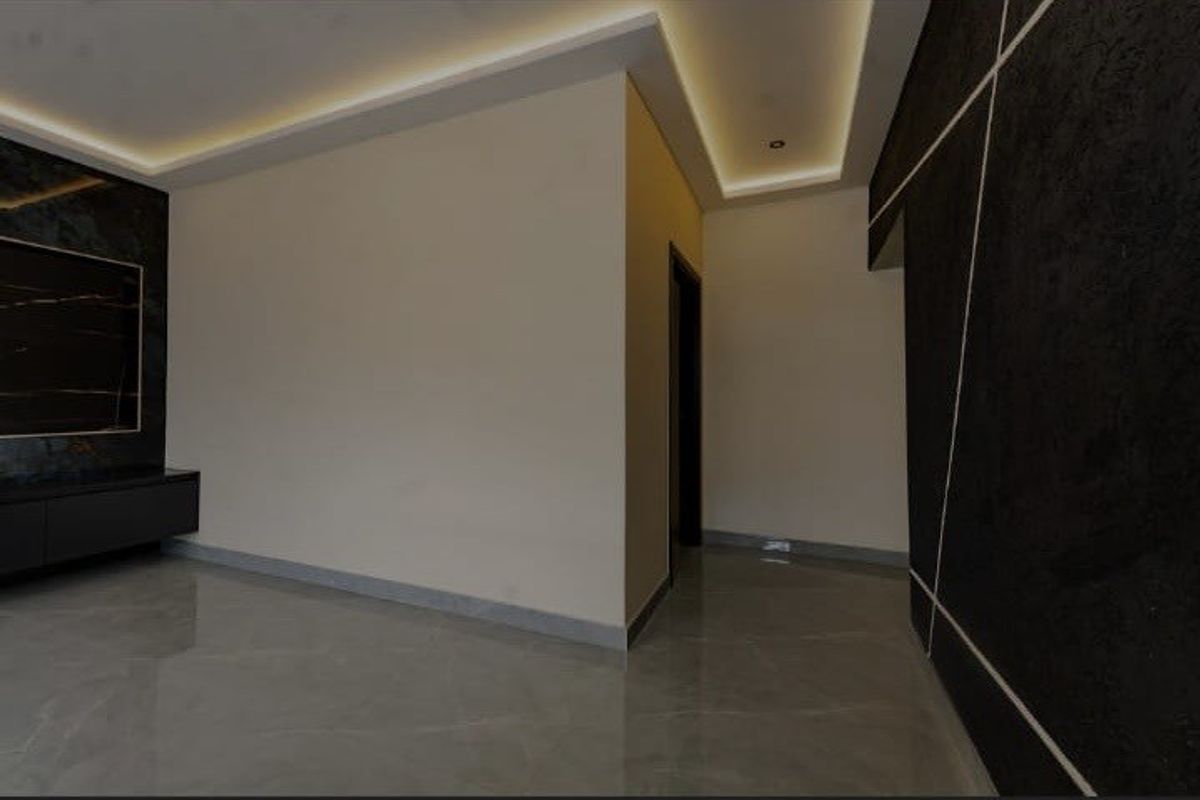 Modern living area featuring polished tile floors, sophisticated cove lighting, and a striking geometric feature wall with a built-in media console.