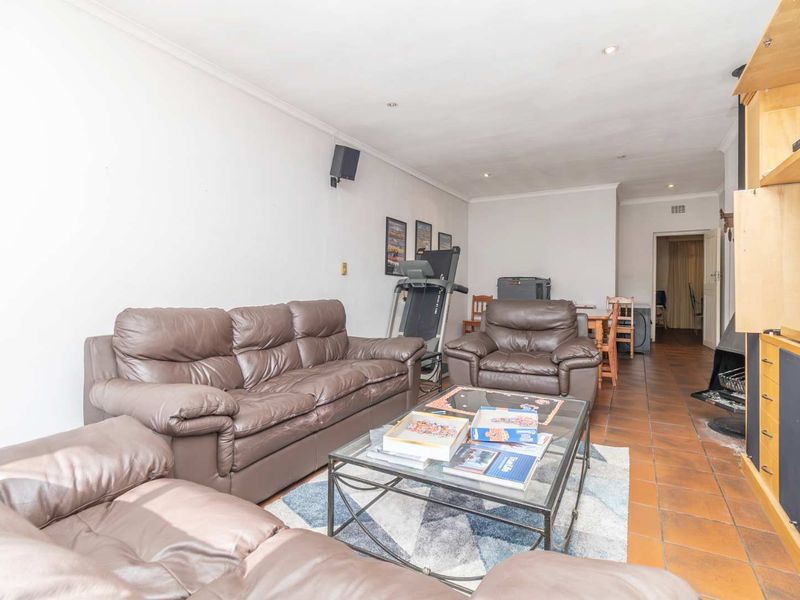 Spacious living area featuring tiled flooring, recessed downlights, and a built-in fireplace, offering a functional layout for comfortable family living.