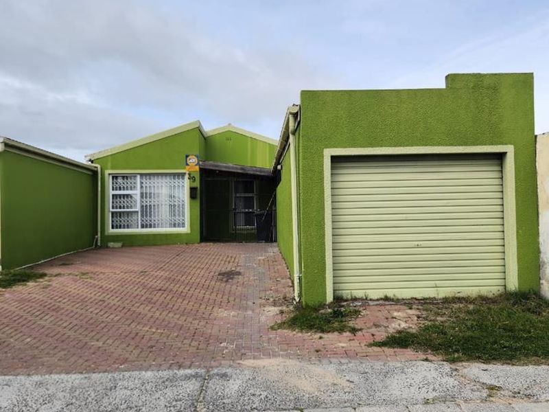 Front elevation of a house featuring a paved driveway, single roller garage door, and security-fitted entrance.