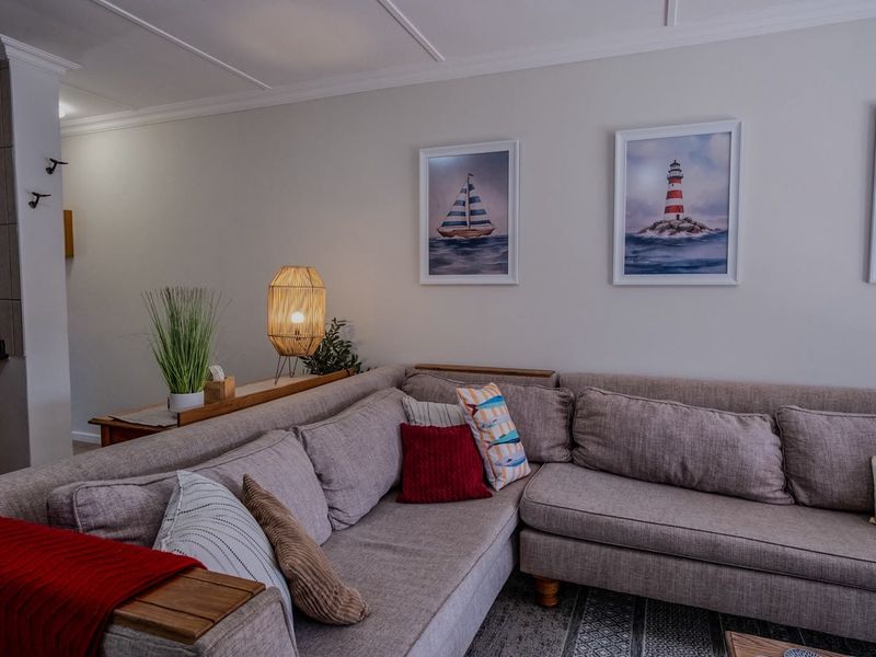 A comfortable living room area featuring crown molding and neutral wall finishes, providing a cozy and inviting space for relaxation.