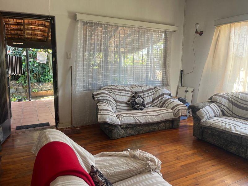 Living room featuring hardwood flooring and direct access to an outdoor patio area through a sliding door.