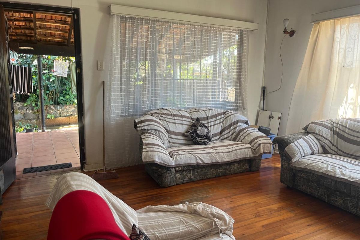 Living room featuring hardwood flooring and direct access to an outdoor patio area through a sliding door.