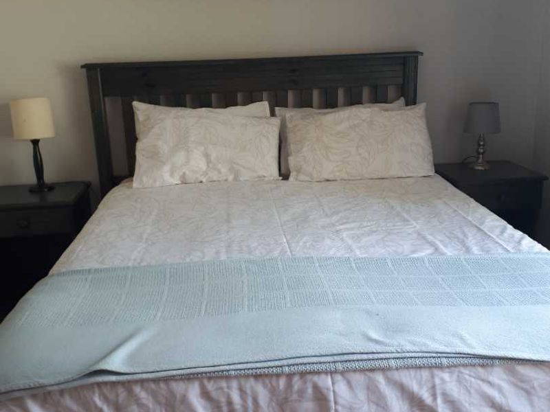 A standard bedroom featuring neutral wall finishes and a functional layout.
