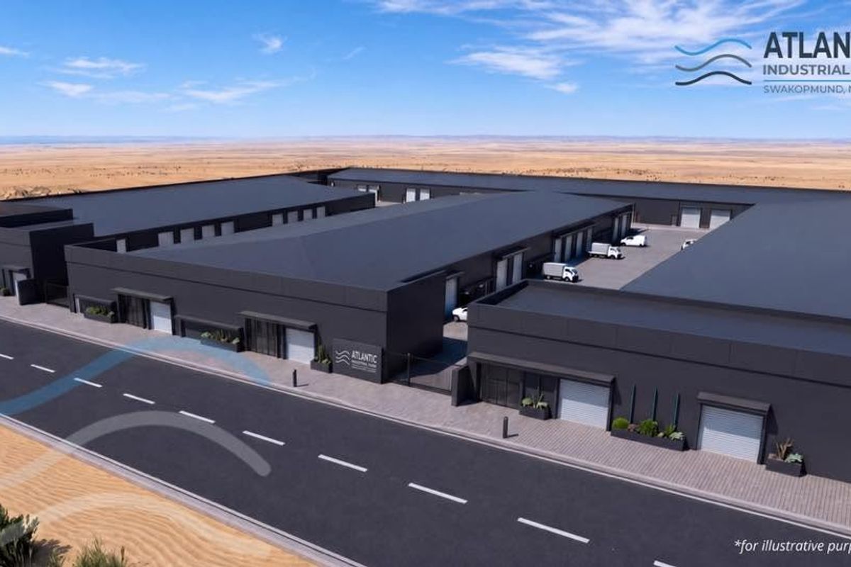 Aerial view of the Atlantic Industrial Park in Swakopmund, featuring modern warehouse units with roller shutter doors and paved access roads.