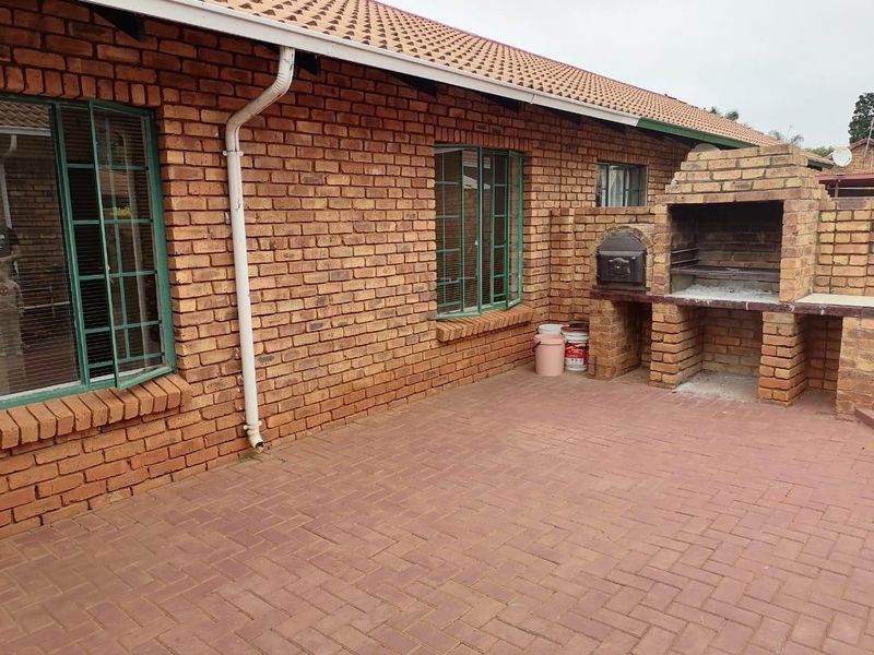 Outdoor patio area featuring brick paving and a built-in brick braai, providing a functional space for outdoor entertaining.