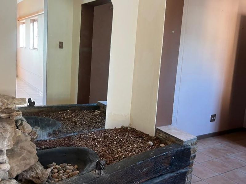 Entrance area featuring a built-in stone water feature and tiled flooring, leading into the home interior.