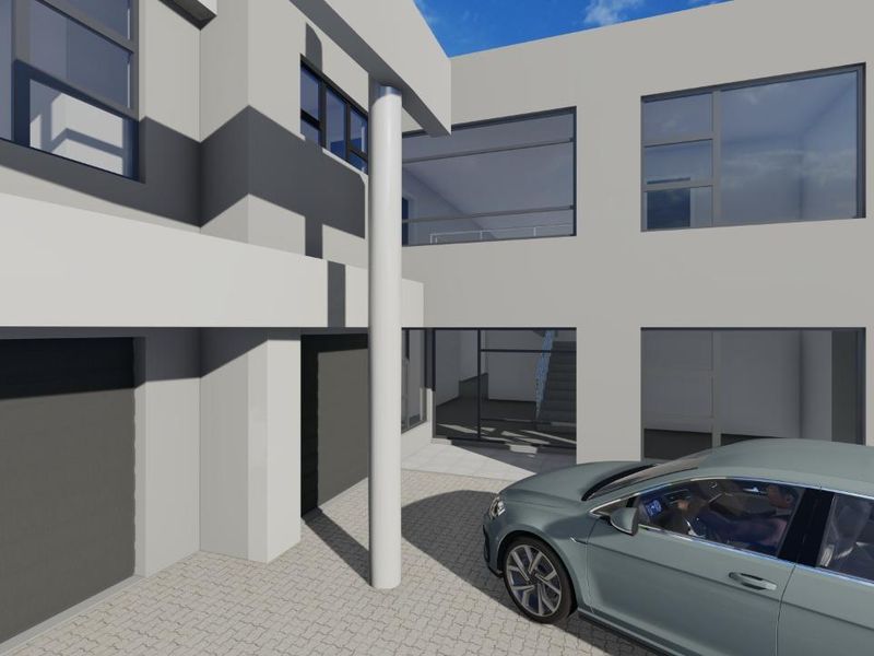 A modern architectural exterior view of a contemporary house featuring a paved driveway, garage access, and large glass windows.