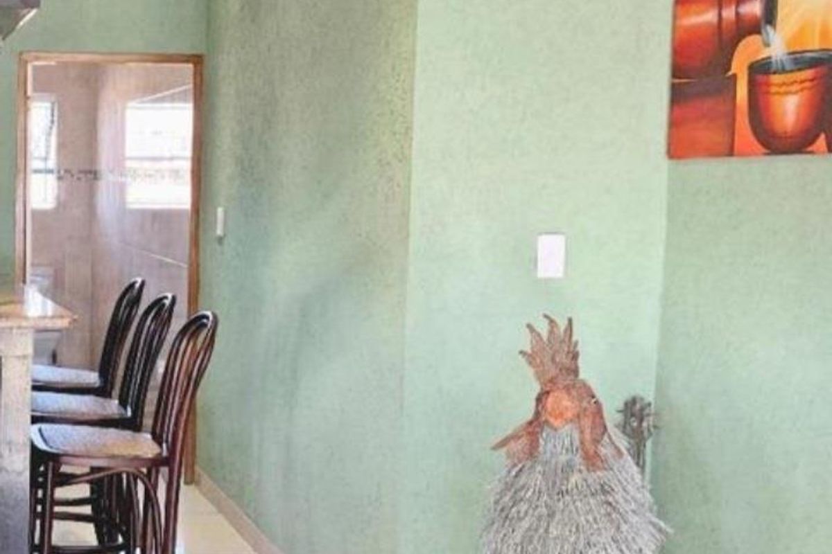 A view of an interior space featuring tiled flooring, recessed ceiling lighting, and a textured green wall finish.