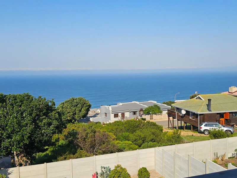 Elevated coastal view overlooking the surrounding neighbourhood, residential properties, and the ocean horizon.