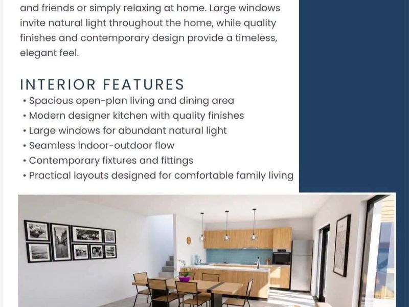 A bright open-plan living, dining, and kitchen area featuring modern cabinetry, a central island, and large sliding doors leading to outdoor space.
