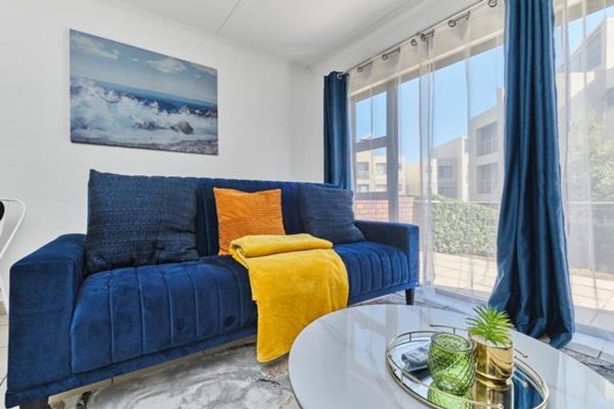 A bright living room featuring a large sliding glass door that provides ample natural light and access to the exterior.
