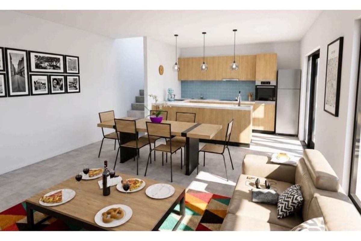 Modern open-plan living and dining area featuring a contemporary kitchen with light wood cabinetry, a central island, and integrated appliances.