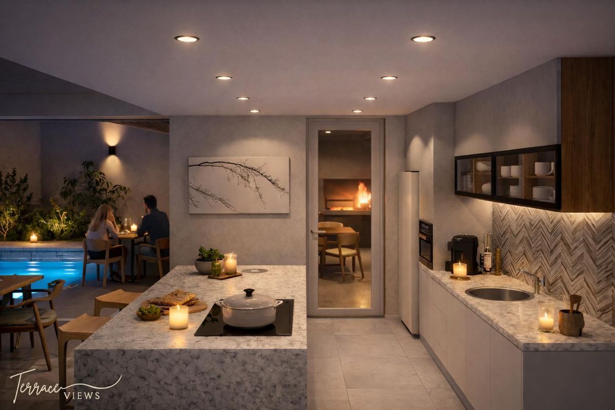 Modern kitchen featuring a stone island with integrated cooktop, sleek cabinetry, and high-end finishes, seamlessly connecting to an outdoor patio and pool area.