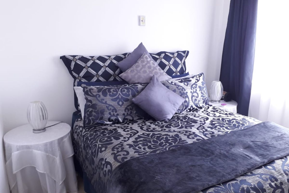 A bedroom featuring neutral wall finishes and a functional electrical outlet, providing a clean and simple space for rest.