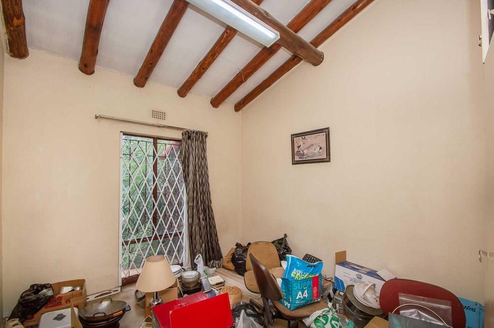Both 2nd and third bedrooms have high ceilings with exposed beams