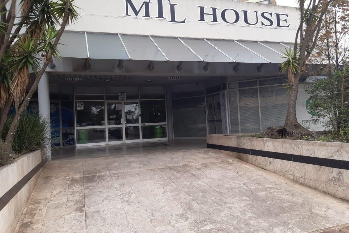 Front entrance of MTL House featuring a tiled ramp, glass doors, and a metal awning, suitable for commercial retail or office use.