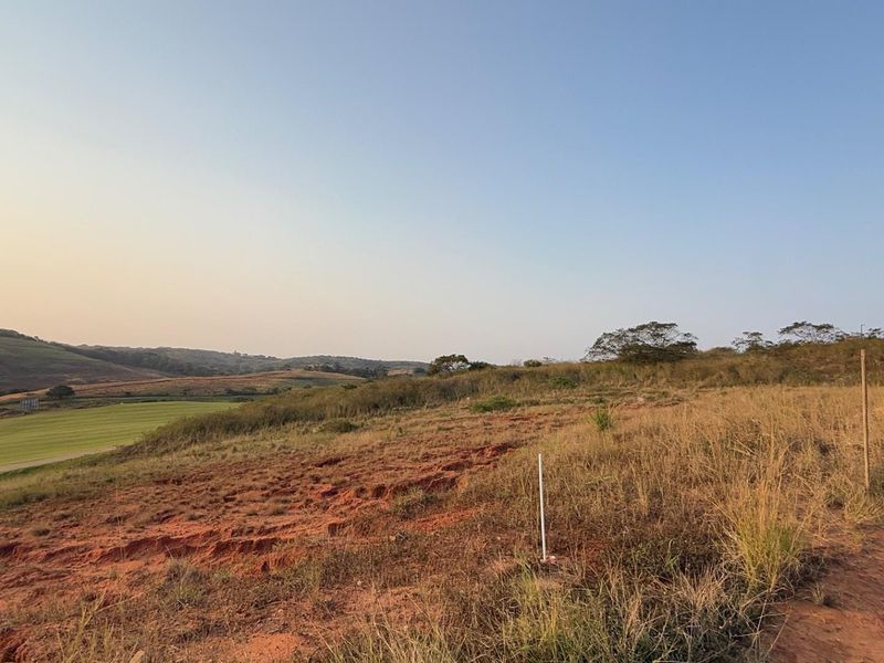 A wide-angle view of the vacant residential land, showcasing the natural topography and surrounding landscape.