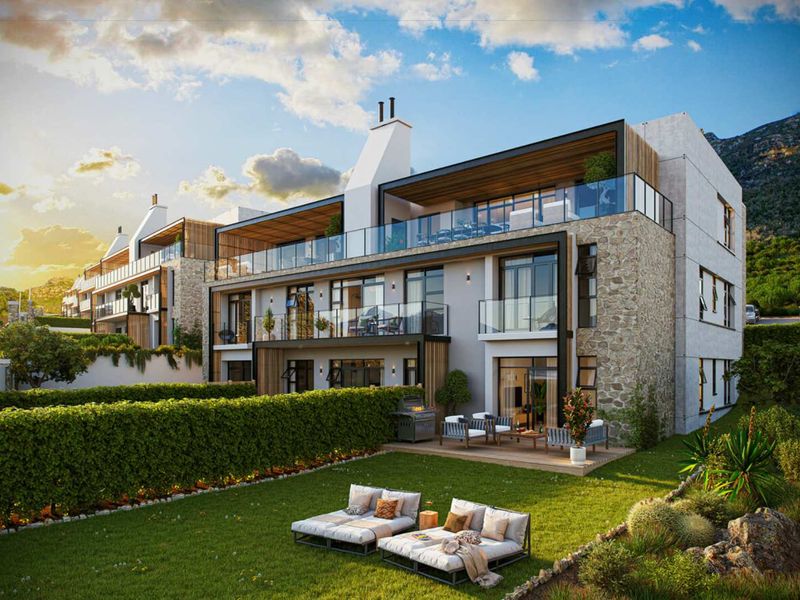 Modern apartment complex featuring stone-clad exterior, spacious balconies with glass balustrades, and ground-floor units with private garden access and timber decking.
