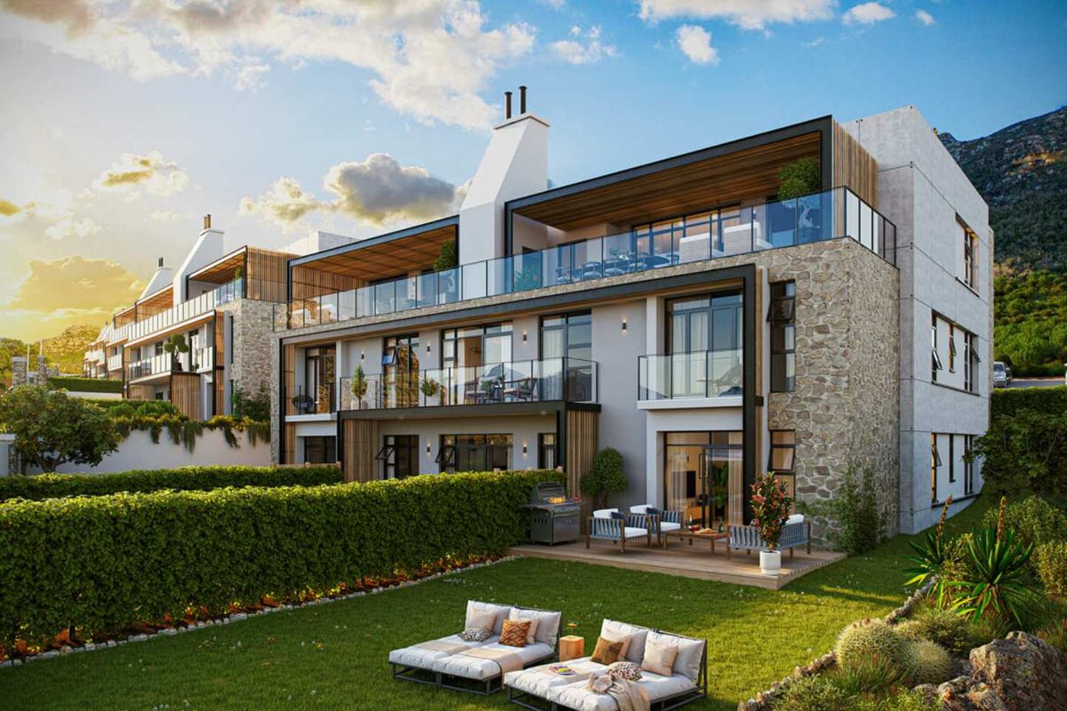 Modern apartment complex featuring stone-clad exterior, spacious balconies with glass balustrades, and ground-floor units with private garden access and timber decking.