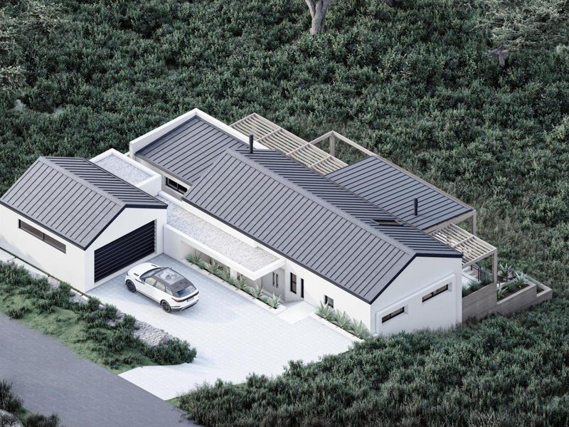 Aerial view of a modern residential property featuring a metal roof, attached garage, paved driveway, and timber pergola set within a landscaped environment.