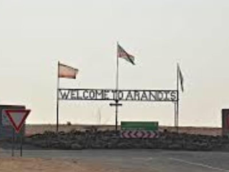 A welcome sign for the town of Arandis, located in a desert landscape.