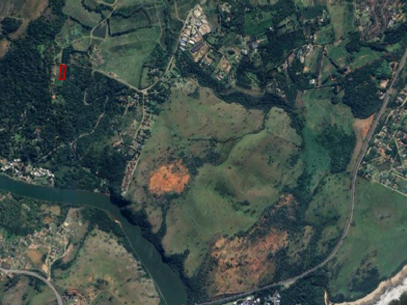 An aerial satellite view showing the residential land parcel in relation to the surrounding coastal landscape and natural terrain.