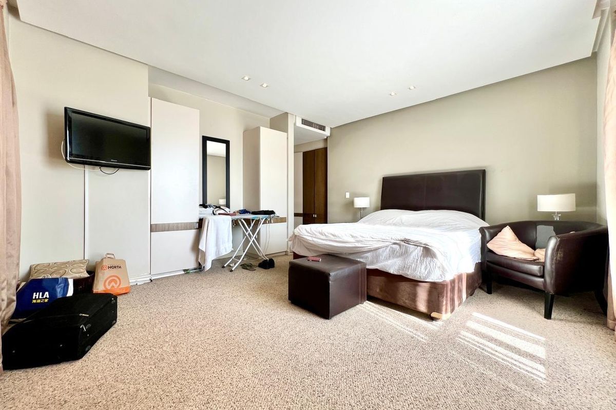 Spacious bedroom featuring built-in wardrobes, recessed lighting, and ducted air conditioning, offering a comfortable layout with neutral wall finishes.