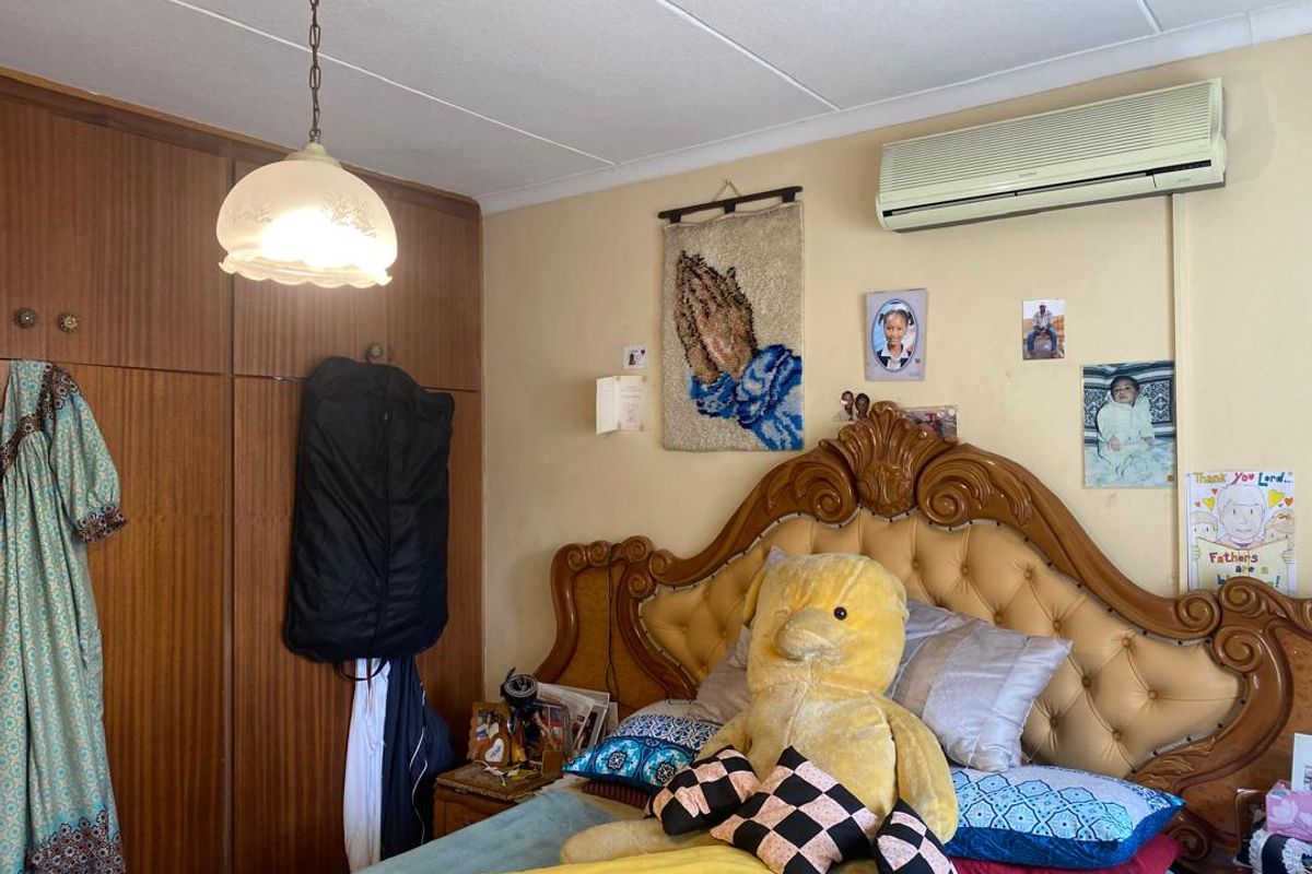 A bedroom featuring built-in wooden cabinetry and a wall-mounted air conditioning unit.